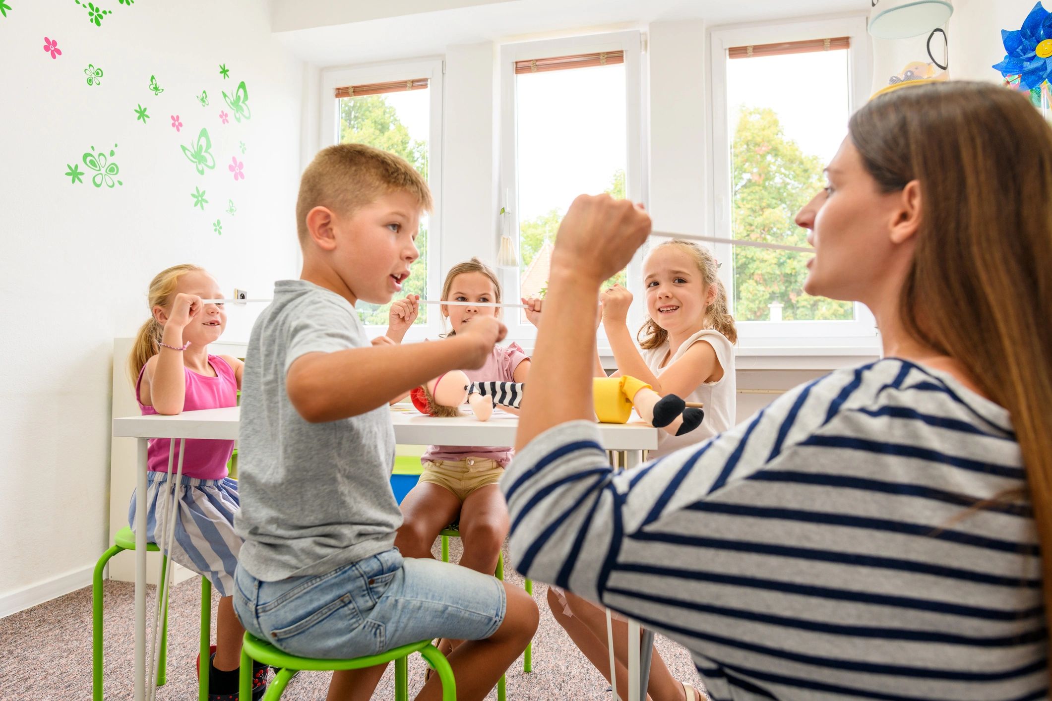Children doing playful movement activities with a teacher