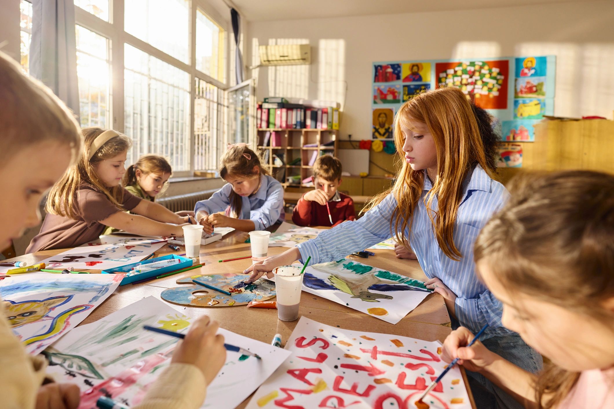 Children painting during an art class